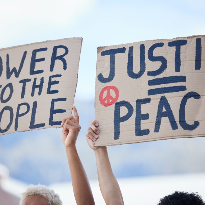 protest crowd and activism for peace climate change and justice in street with poster in hands p